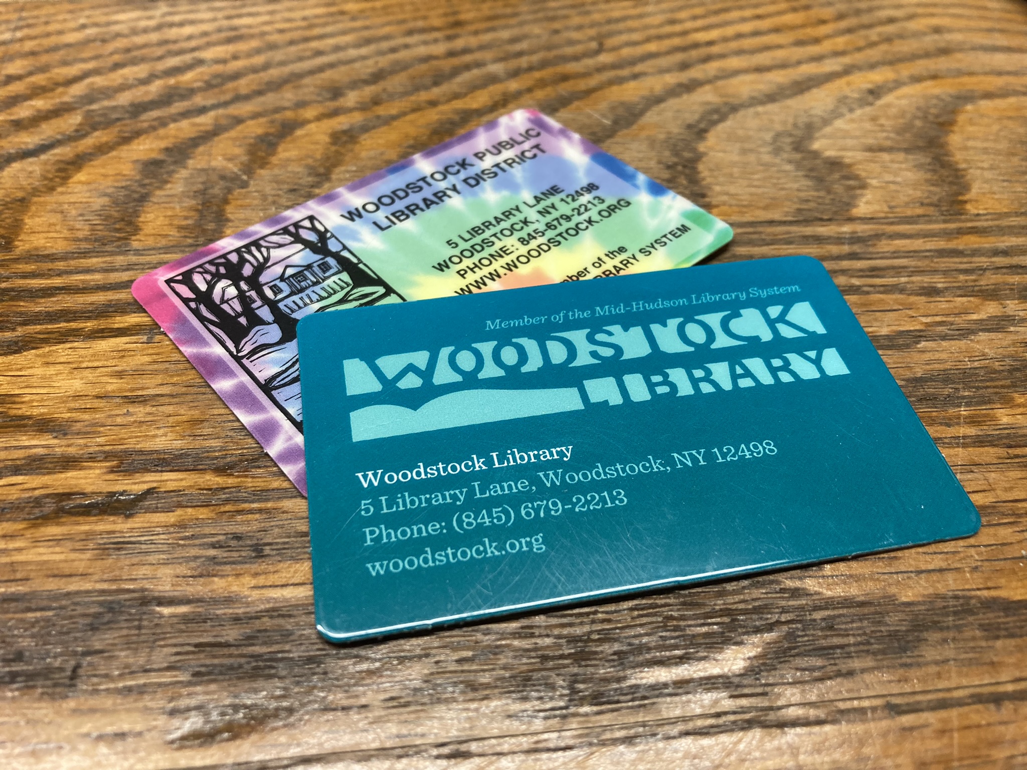 Neil Gaiman holding up his library card.